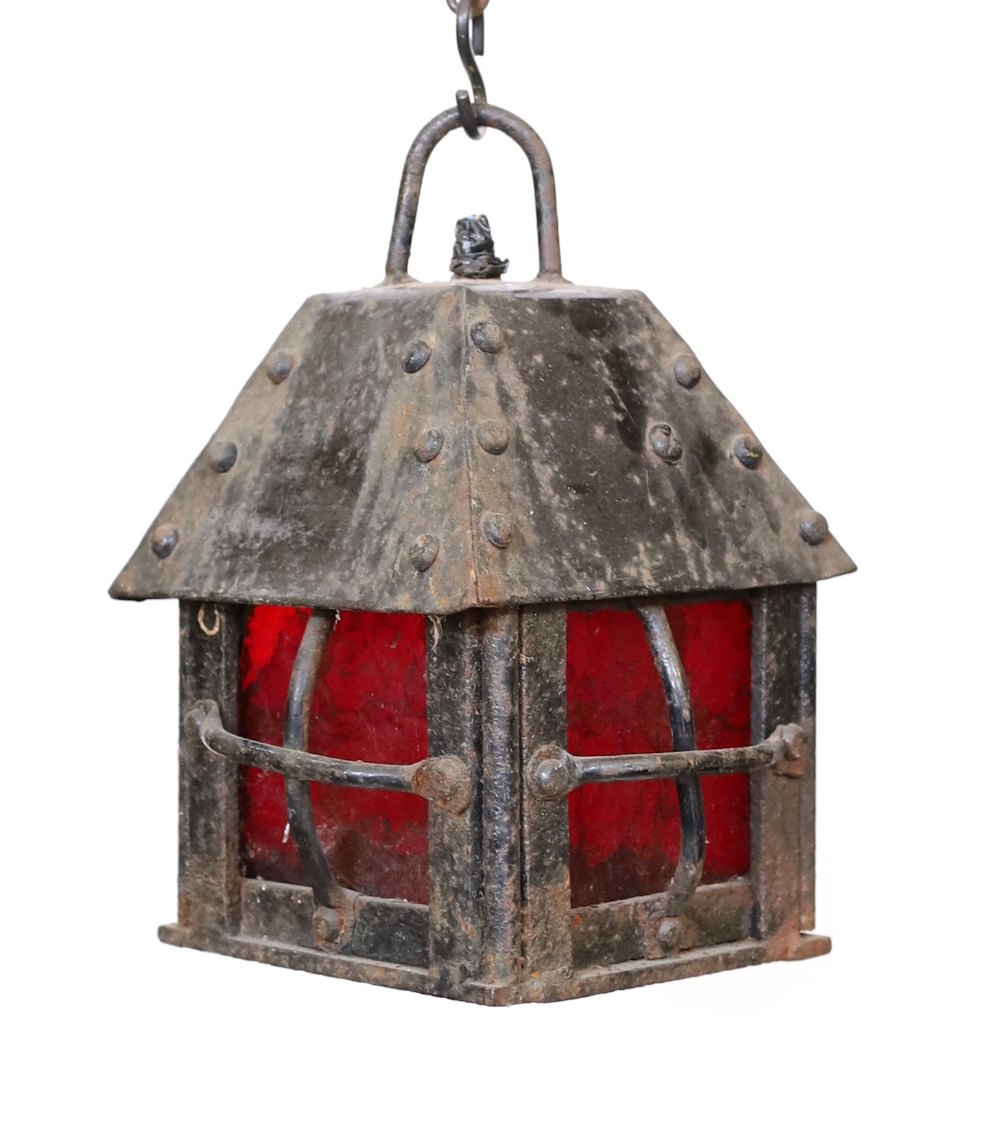 An early 20th century English wrought iron lantern with a red glass panels, height 29cm. width 20cm